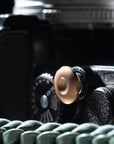 bronze shutter release button, by Komaru